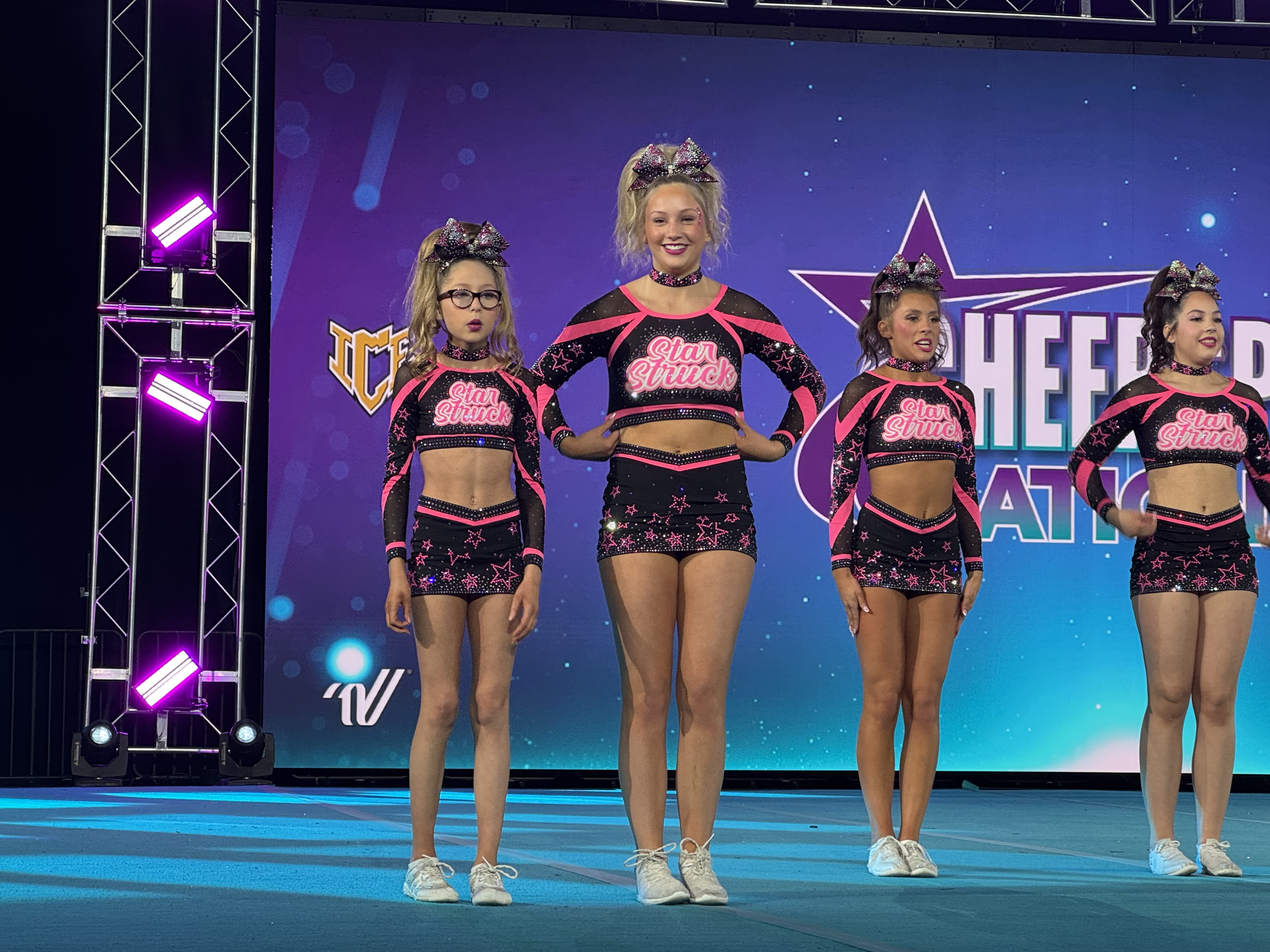 Ashlyn and teammates lined up on stage at Cheersport Nationals