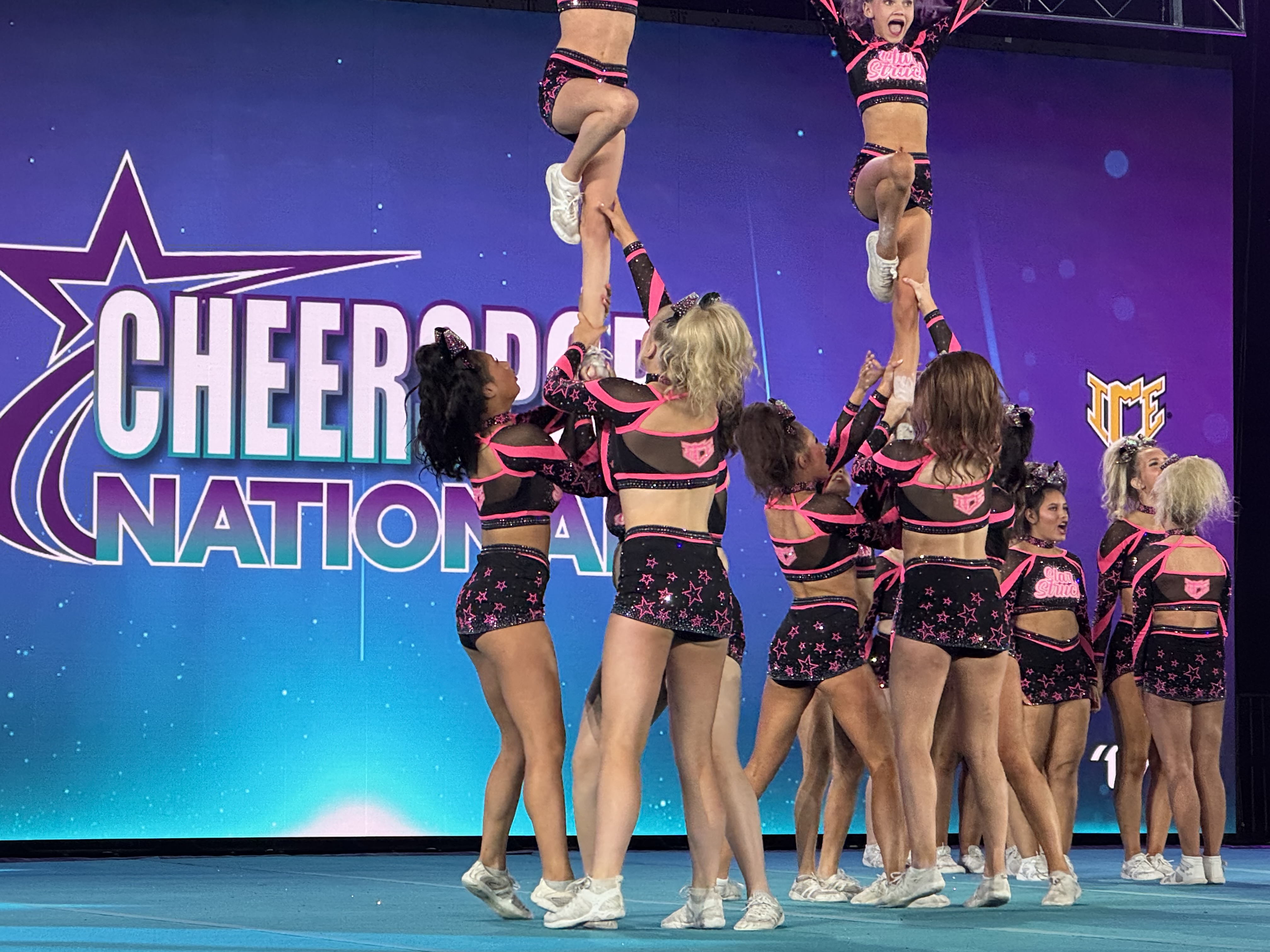 Stunt group tossing a flyer during a routine
